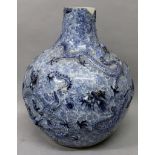 AN 18TH/19TH CENTURY CHINESE BLUE & WHITE MOULDED DRAGON BOTTLE VASE, the sides decorated with