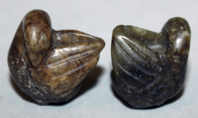 A PAIR OF MINIATURE JADE-LIKE MODELS OF WATER FOWL, each preening its wing, 0.75in high.