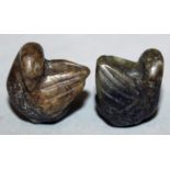 A PAIR OF MINIATURE JADE-LIKE MODELS OF WATER FOWL, each preening its wing, 0.75in high.