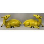 A LARGE MIRROR PAIR OF YELLOW GLAZED PORCELAIN MODELS OF DEER, each seated with its head turned back