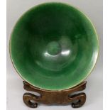 A 19TH CENTURY CHINESE CONICAL GREEN GLAZED CRACKLEGLAZE PORCELAIN BOWL, together with a wood