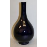 A CHINESE MONOCHROME PORCELAIN BOTTLE VASE, the sides applied with a purple-blue aubergine glaze,