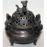 A CHINESE BRONZE TRIPOD CENSER & COVER, weighing 545gm, the lotus pierced cover surmounted by a