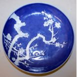 A WHITE SLIP DECORATED BLUE-GROUND PORCELAIN SAUCER DISH, the interior decorated in low relief