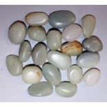 A GROUP OF TWENTY CHINESE CELADON GREEN JADE PEBBLES, of various shapes and sizes, the largest 1.1in