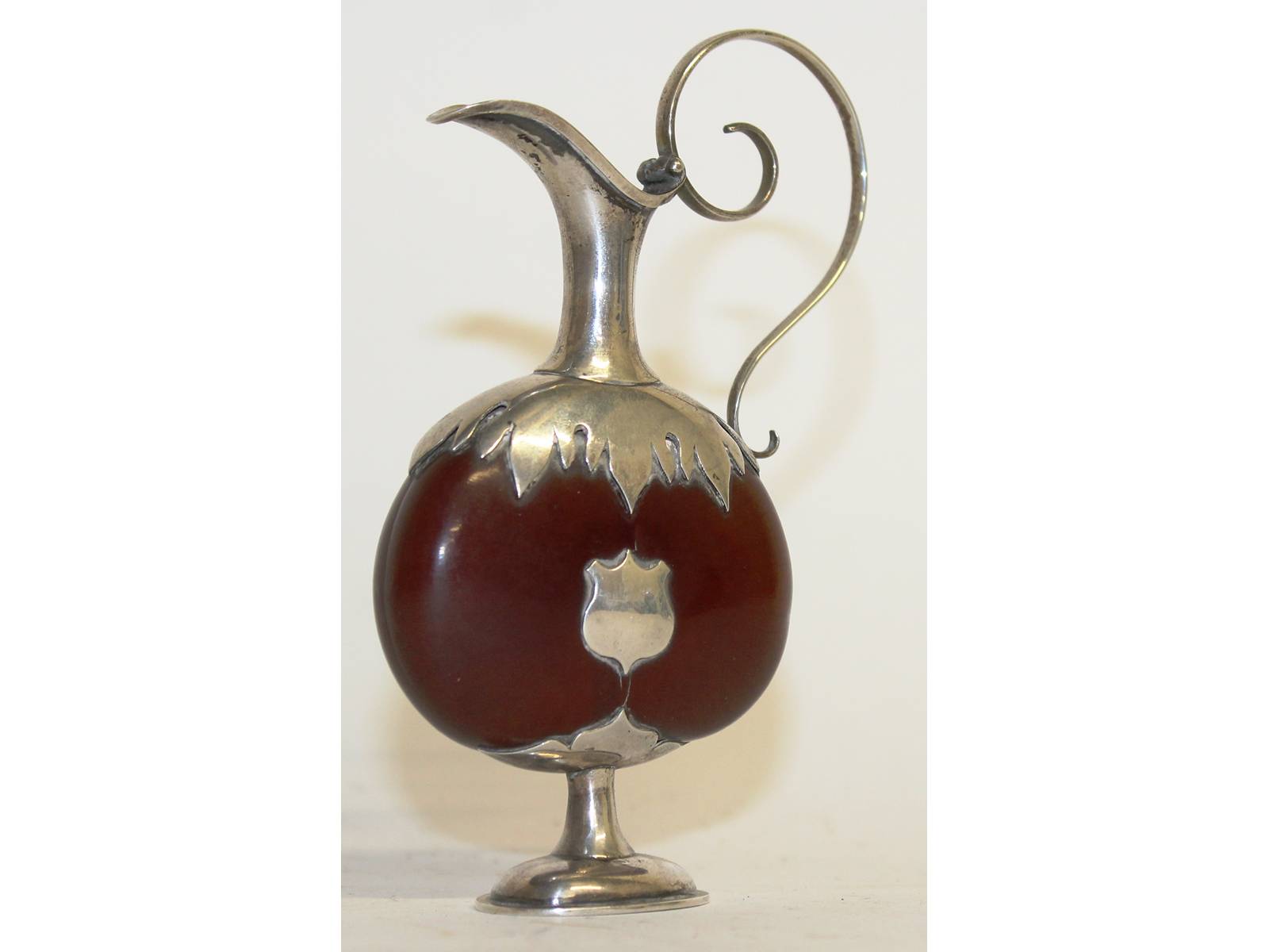 A Georgian silver mounted seed pod as a jug. 11ins high.