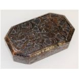 A Chinese hardstone weight, carved with flowers and canted corners. 10cms long, 6cms wide.