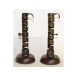 A pair of early 17th century steel candlesticks, on circular wooden bases. 7ins high.