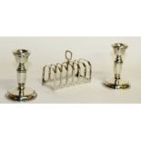 A six division toast rack, Birmingham 1937, and a pair of circular candlesticks, 3.75ins high,