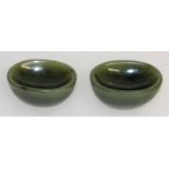 A pair of Chinese green jade oval salts. 5cms long.