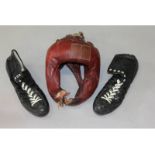 A pair of old boxing boots, Adidas, size 10.5, and a leather head guard.