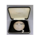 A silver medallion "Mans First Landing on the Moon", No. 2363, in a case.