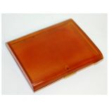 A blonde tortoiseshell cigarette case, with silver fittings. 8cms x 10cms.