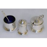 A three piece silver circular condiment set.