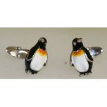 A pair of sterling silver and enamel cufflinks in the form of penguins.