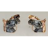 A pair of sterling silver and enamel cufflinks in the form of horses heads.