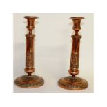 A pair of early French circular candlesticks. 10.5ins high.