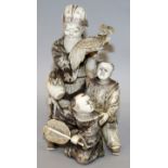 A FINE QUALITY JAPANESE MEIJI PERIOD IVORY OKIMONO OF A BEARDED DAIKOKU & TWO BOYS, the sage holding