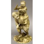 A GOOD QUALITY SIGNED JAPANESE MEIJI PERIOD IVORY OKIMONO OF A MAN & BOY, in playful postures, the