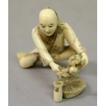A SIGNED JAPANESE MEIJI PERIOD IVORY OKIMONO OF A MAN TRIMMING A BUNCH OF FLOWERS, the man squatting