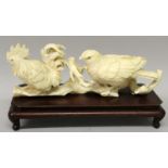 A GOOD QUALITY SIGNED JAPANESE MEIJI PERIOD IVORY OKIMONO OF A HAWK & A COCKEREL, together with a