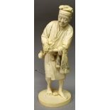 A LARGE FINE QUALITY SIGNED JAPANESE TOKYO SCHOOL IVORY OKIMONO OF A STANDING MAN, holding a small