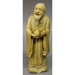 A GOOD QUALITY SIGNED JAPANESE IVORY OKIMONO OF A SAGE, standing in flowing robes and holding a