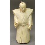 A LARGE UNUSUAL & FINE QUALITY SIGNED JAPANESE MEIJI PERIOD TOKYO SCHOOL IVORY OKIMONO OF A STANDING