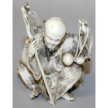 A GOOD JAPANESE MEIJI PERIOD IVORY OKIMONO OF A BEARDED SAGE, squatting, and in the company of a
