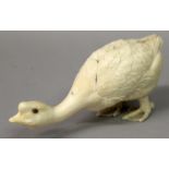 A SIMILAR FINE QUALITY JAPANESE MEIJI PERIOD IVORY CARVING OF A GOOSE, its head strained forwards,