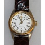 A LADIES WHITE FACE BAUME-MERCIER BAUMATIC WRISTWATCH with leather strap.