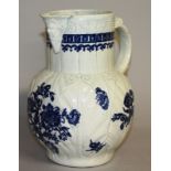 AN 18TH CENTURY LIVERPOOL MASK JUG decorated with floral sprays and a cell border.