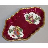 AN 18TH CENTURY WORCESTER SPOON TRAY painted with classical musicians on a claret ground.