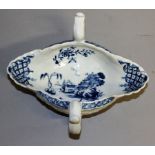 AN 18TH CENTURY WORCESTER DOUBLE HANDLED SAUCEBOAT of moulded form, the exterior with four