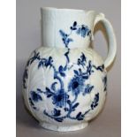 AN 18TH CENTURY WORCESTER CIDER JUG of Dutch painted with trailing flowers in under-glaze blue,