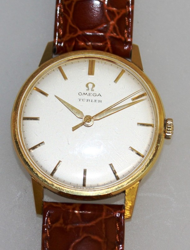 A GENTLEMAN'S 18CT GOLD OMEGA "TURLER" WRISTWATCH with leather strap.