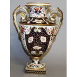 AN EARLY 19TH CENTURY DERBY LARGER TWO HANDLED VASE painted in imari style.