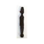 A CARVED WOOD TRIBAL PIPE TAMPER. 14cms long.