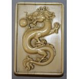 A SMALL CHINESE IVORY-LIKE PLAQUE, decorated with a dragon to one side and a phoenix to the