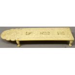 A FINE QUALITY 19TH CENTURY CHINESE CANTON IVORY CRIBBAGE BOARD,supported on four claw feet, the top