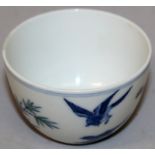 A CHINESE DOUCAI PORCELAIN TEABOWL, the sides decorated with two birds and a garden scene of