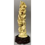 A LARGE JAPANESE MEIJI PERIOD IVORY OKIMONO, together with a fitted wood stand, carved in the form