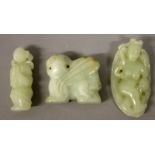 A CHINESE PALE CELADON JADE-LIKE MODEL OF A WINGED PIXIU, 1.8in wide x 1.6in high; together with two