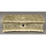 A GOOD 19TH CENTURY CHINESE CANTON IVORY CASKET, the shaped and hinged cover carved in deep relief