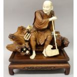 A LARGE FINE QUALITY JAPANESE SIGNED MEIJI PERIOD SECTIONAL WOOD & IVORY OKIMONO OF A SEATED FARMER,