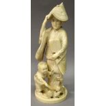 A SIGNED JAPANESE MEIJI PERIOD IVORY OKIMONO OF A LADY & HER SON, the lady holding a stringed