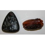 A CHINESE TRIANGULAR STONE PENDANT, carved to one side with leaf-stemmed fruit, 2in high x 1.7in