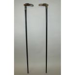 A PAIR OF 19TH CENTURY HORN HANDLED WOOD WALKING STICKS, the sticks with engraved silver-metal