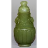 A SMALL CHINESE OLIVE-GREEN JADE-LIKE VASE & COVER, of archaic form, the stone with russet