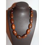 A GOOD HORN GRADUATED BEAD NECKLACE, possibly Rhinoceros horn, weighing 85gm, the largest bead 1.1in